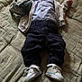 baby, infant, blanket, plush_toy, pacifier, shirt, jacket, pants, sneakers, floor, wood, quilted, clothing, child, laying_down, indoor, cute, soft, comfort, sleepy