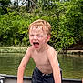 child, boy, shirtless, canoe, water, river, outdoor, nature, trees, greenery, summer, wet_hair, expression, playing, adventure, yelling, bare_chest, daylight, recreation, fun