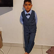 Lucas Matias participe au concours pour gagner de l'argent avec cette photo : child, boy, suit, bow_tie, barefoot, standing, indoor, tile_floor, wall, portrait, formal_wear, person, casual_pose, short_hair, blue_shirt, vest, pants, looking_at_camera, calm_expression, home