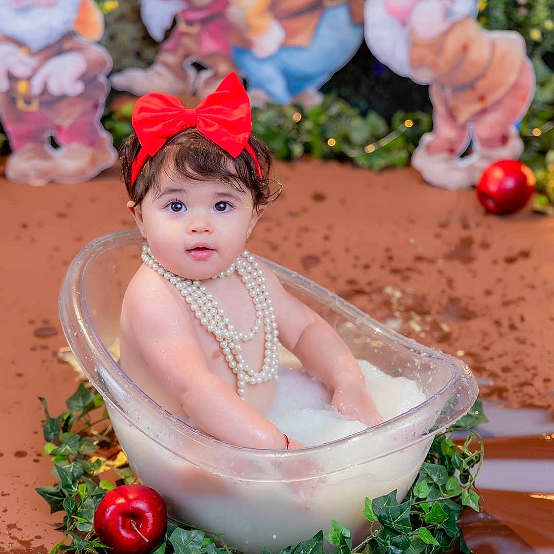 Jenny joined the competition — help win amazing prizes! baby, child, infant, portrait, smiling, red_bow, pearls, bathtub, milk_bath, holiday, snow_white, seven_dwarfs, apples, greenery, outdoor, festive, costume, sitting, studio_photography, decor