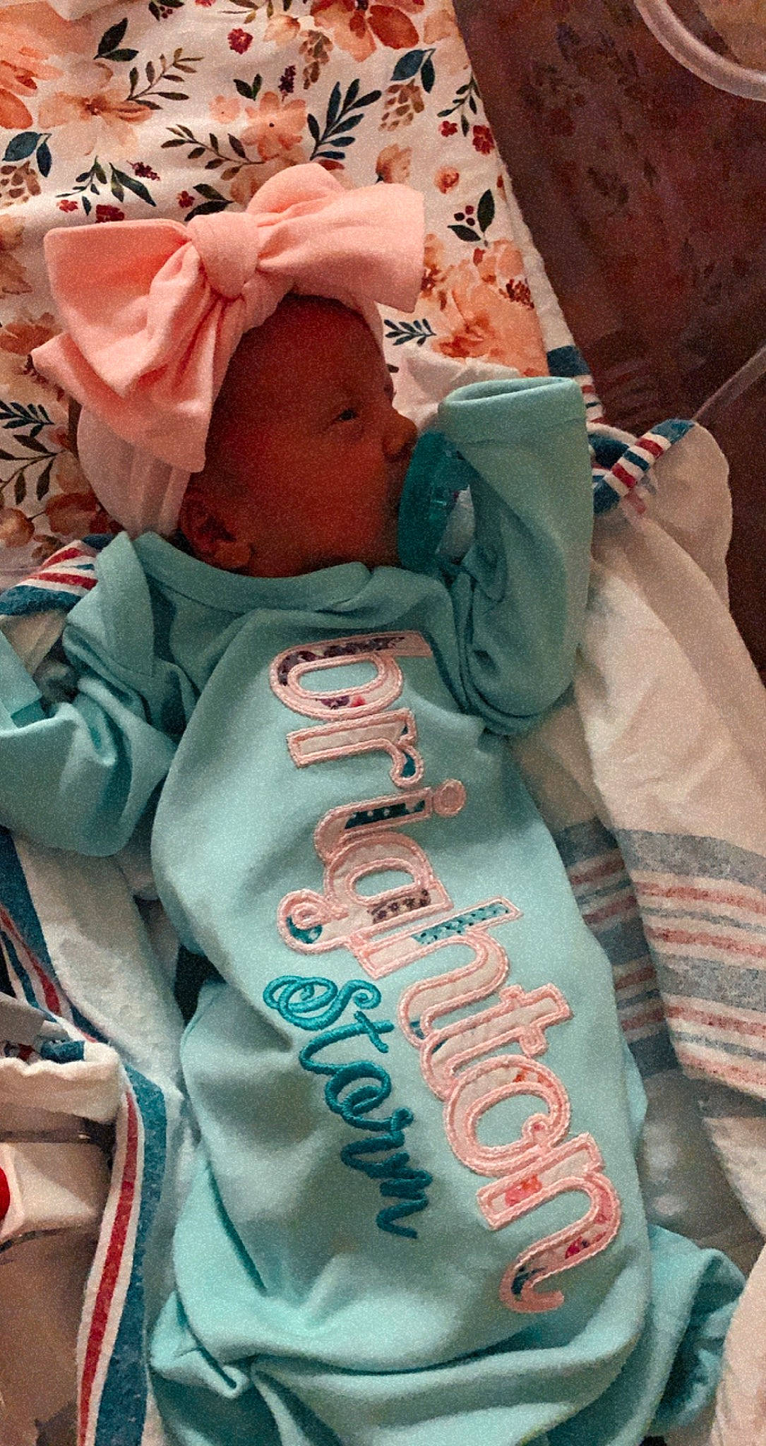 Brighton is registered to the contest to win money with this photo: aqua, baby_products, baby_toddler_clothing, linens, peach, person, pink, teal, turquoise