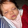 Valentina is registered to the contest to win money with this photo: baby, sleeping, face, hair, blanket, pink_clothing, red_blanket, striped_cushion, closeup, peaceful, child, soft_texture, indoors, resting, cute, portrait, human, infant, eyelashes, skin