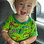 Grayson is registered to the contest to win money with this photo: boy, car_interior, casual, child, cute, daylight, face, green_clothing, hair, happy, indoors, playful, portrait, seat, short_sleeves, shorts, smiling, teenage_mutant_ninja_turtles, toddler, window