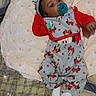 baby, bed, blanket, child, clothing, comfort, cute, headband, indoors, infant, lying_down, mickey_mouse, minnie_mouse, pacifier, packaging, pattern, plaid, red, sleepwear, soft_toy