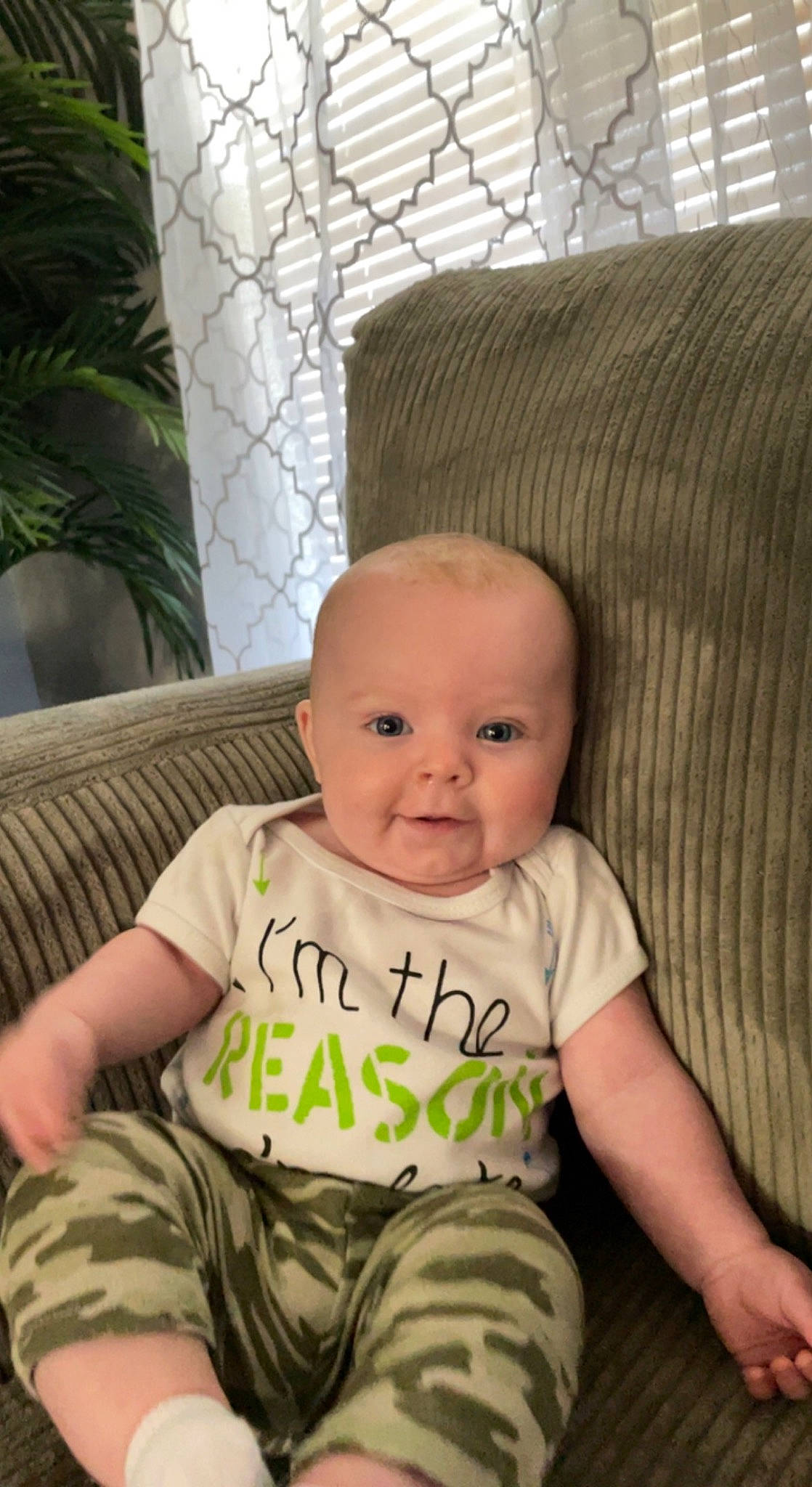 Jackson is registered to the contest to win money with this photo: baby, baby_toddler_clothing, cheek, child, comfort, couch, flooring, fun, happy, houseplant, iris, person, plant, room, sitting, skin, smile, toddler, wood