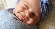 Bauer joined the competition — help win amazing prizes! baby, newborn, smile, headband, bow, blanket, wrapped, sleeping, peaceful, soft, texture, cozy, indoors, portrait, infant, cute, child, face, resting, warm