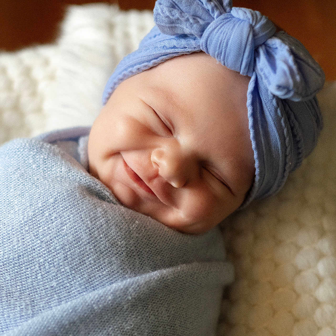 Bauer joined the competition — help win amazing prizes! baby, newborn, smile, headband, bow, blanket, wrapped, sleeping, peaceful, soft, texture, cozy, indoors, portrait, infant, cute, child, face, resting, warm