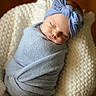 Bauer is registered to the contest to win money with this photo: baby, newborn, sleeping, wrapped, blanket, headband, blue, white, cushion, soft, cozy, peaceful, infant, portrait, indoors, closeup, cute, child, resting, wrapped_in_blanket