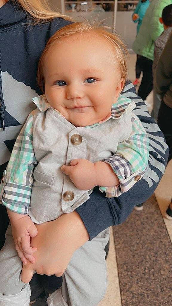 Bruce is registered to the contest to win money with this photo: baby, baby_toddler_clothing, cheek, child, comfort, elbow, eye, finger, happy, human_leg, iris, joy, pattern, person, sitting, skin, sleeve, smile, t_shirt, thigh