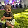 Ostap joined the competition — help win amazing prizes! barefoot, child, clothing, curly_hair, daylight, event, expression, festival, grass, happy, lighting, outdoor, people, playful, purple_light, stage, stroller, tent, toddler, wheel