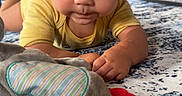 Braylen is registered to the contest to win money with this photo: baby, carpet, child, curious, elephant_toy, eyes, face, furniture, home, indoor, infant, lying_down, natural_light, photography, plush_toy, portrait, rug, teething_toy, tummy_time, yellow_shirt