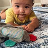 baby, carpet, child, curious, elephant_toy, eyes, face, furniture, home, indoor, infant, lying_down, natural_light, photography, plush_toy, portrait, rug, teething_toy, tummy_time, yellow_shirt