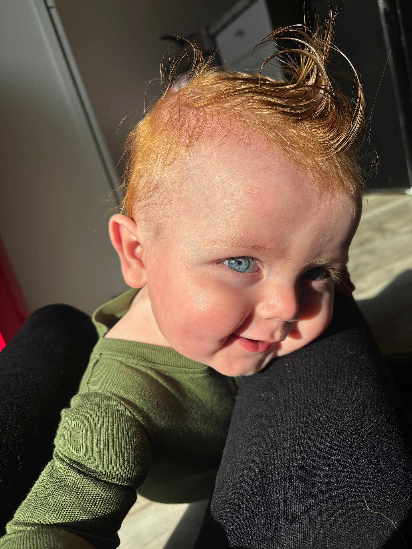 Nico is registered to the contest to win money with this photo: baby, child, blue_eyes, ginger_hair, spiky_hair, green_clothing, smiling, sunlight, portrait, closeup, face, skin, person, happy, infant, cheeks, indoor, legs, clothing, cute