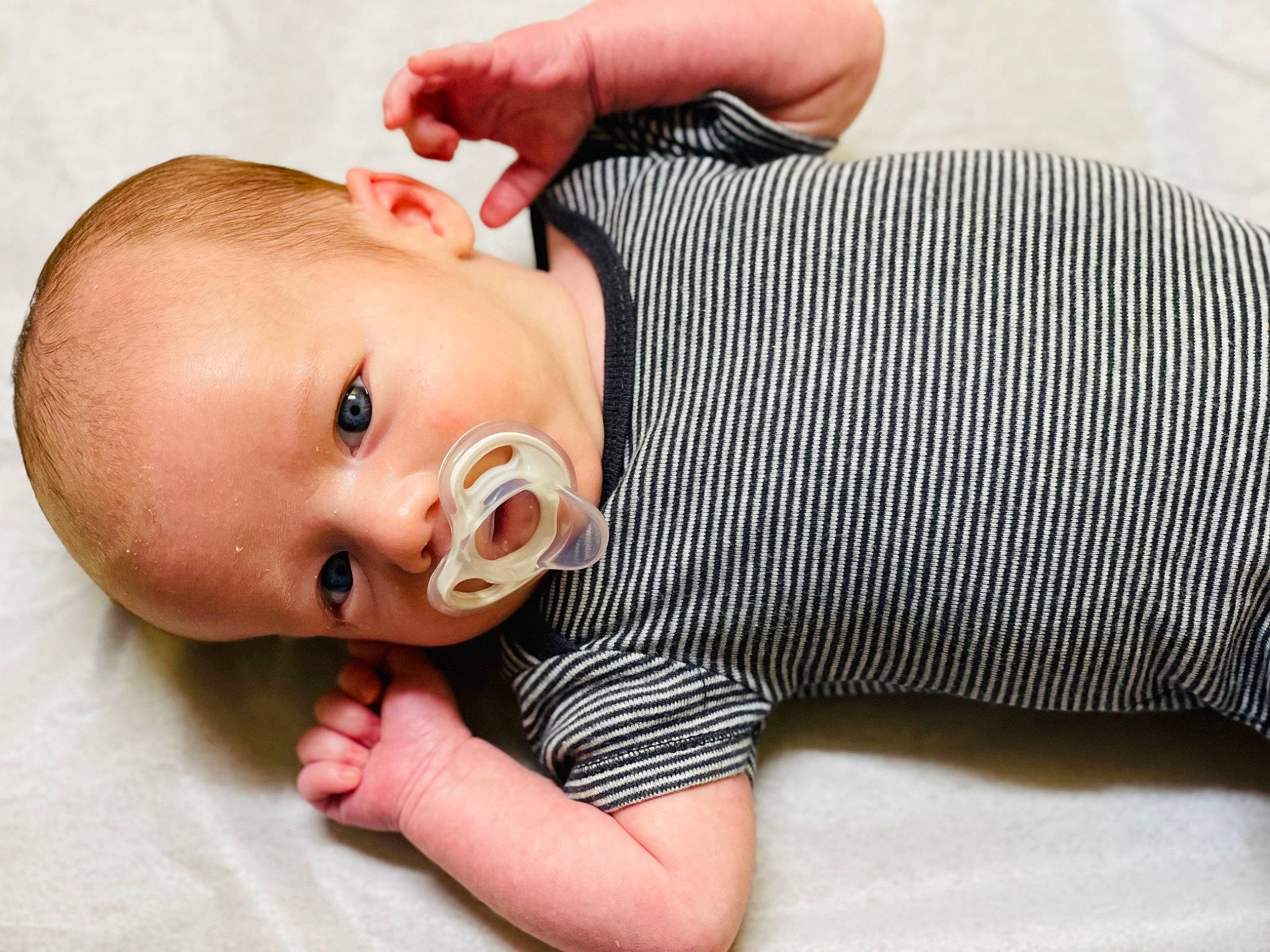 Deluca is registered to the contest to win money with this photo: arm, baby, baby_toddler_clothing, cheek, child, chin, collar, comfort, eyelash, facial_expression, finger, hand, happy, lip, nail, nose, person, skin, sleeve, toddler