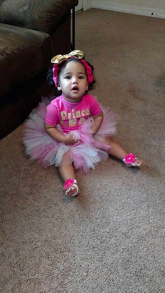 Leah joined the competition — help win amazing prizes! baby, baby_toddler_clothing, child, couch, dress, event, fashion_accessory, flooring, fun, grass, happy, head, human_leg, magenta, person, pink, sandal, shoe, sitting, toddler