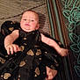 accessories, baby, blanket, bodypart, clothing, couch, dress, face, finger, formalwear, furniture, hand, head, jewelry, newborn, pattern, person, photography, portrait, ring