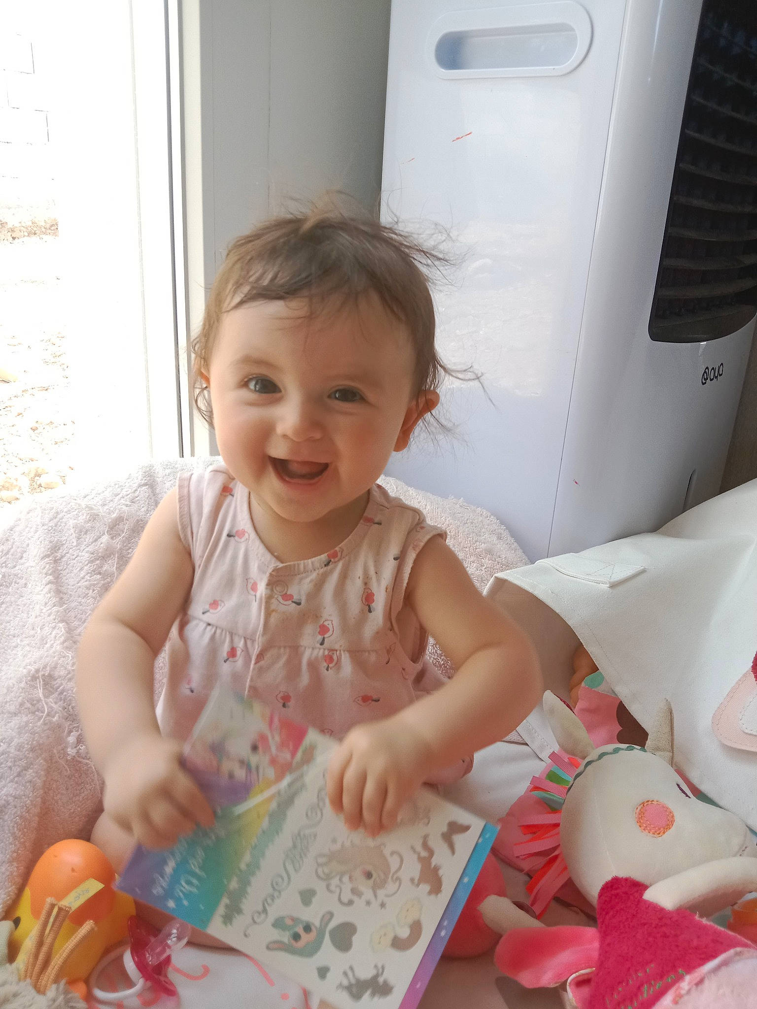 Noélia a rejoint le concours — aidez-le/la à gagner de superbes lots ! baby, baby_playing_with_toys, baby_products, baby_toddler_clothing, child, door, dress, face, fun, happy, joy, linens, pattern, person, pink, play, product, room, sitting, skin