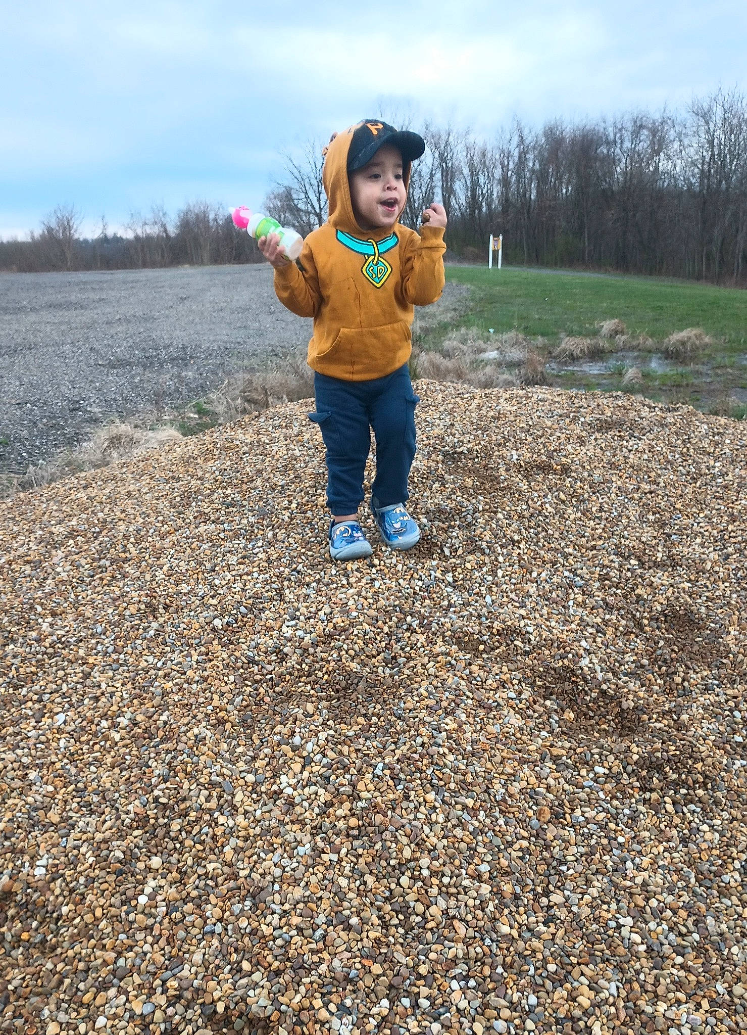 Grayson joined the competition — help win amazing prizes! asphalt, cloud, field, fun, gesture, grass, grassland, happy, headwear, horizon, landscape, natural_landscape, pebble, people_in_nature, person, plant, road_surface, sky, soil, sunlight