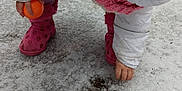 Katrina joined the competition — help win amazing prizes! child, winter_clothing, white_jacket, pink_boots, knitted_scarf, orange_ball, snow, ice, outdoor, curious, cold_weather, ground, frozen, pavement, crouching, hand, winter, play, kid, footwear