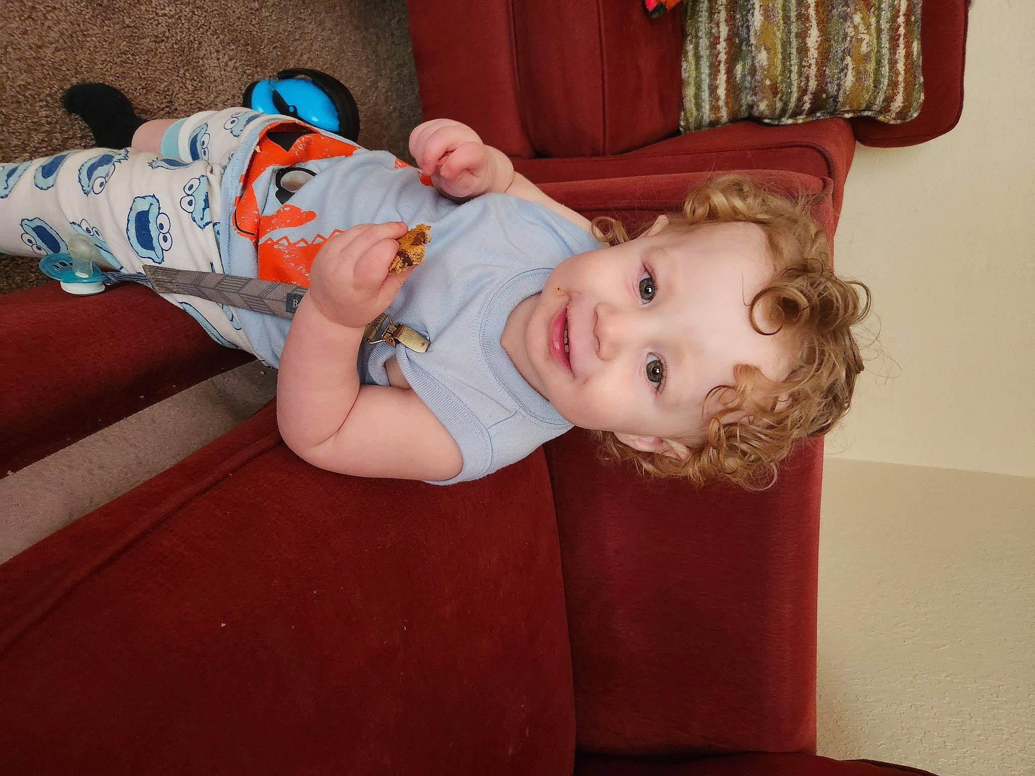 Ambrose is registered to the contest to win money with this photo: baby, baby_products, baby_toddler_clothing, carmine, cheek, child, comfort, flooring, head, human_leg, joy, pattern, person, room, sitting, skin, sleeve, smile, sock, toddler