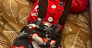 Malachi joined the competition — help win amazing prizes! baby, basket, bow_tie, child, christmas_pajamas, cozy, cushion, cute, face, holiday_outfit, indoors, infant, patterned, peaceful, portrait, red_clothing, resting, sleeping, soft_lighting, suspenders