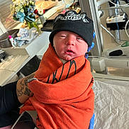Malachi joined the competition — help win amazing prizes! newborn, baby, infant, hospital, blanket, hat, gloves, harley_davidson, medical_equipment, flowers, person, bed, portrait, wrapped, cute, indoor, closeup, holding, toddler, resting
