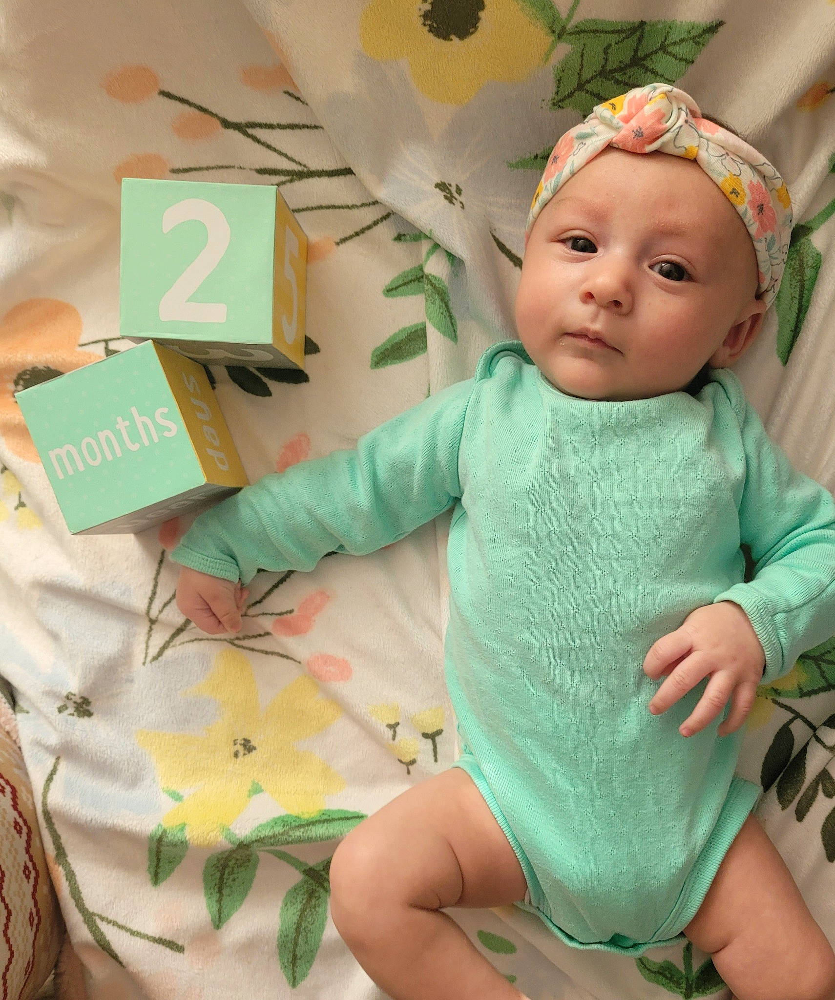 Amariah joined the competition — help win amazing prizes! baby, baby_toddler_clothing, chair, child, costume_hat, finger, green, happy, hat, headband, headwear, leaf, mammal, pattern, person, room, sleeve, sock, t_shirt, textile