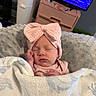 baby, newborn, sleeping, blanket, headband, pink_bow, cozy, soft, cushion, infant, indoors, furniture, television, sleep, child, cute, resting, peaceful, portrait, person