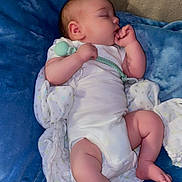 Buddy is registered to the contest to win money with this photo: baby, sleeping, pacifier, blanket, white_clothing, infant, cozy, thumb_sucking, face, peaceful, soft_texture, child, resting, blue_blanket, wrapped, indoors, cute, newborn, comfort, relaxation