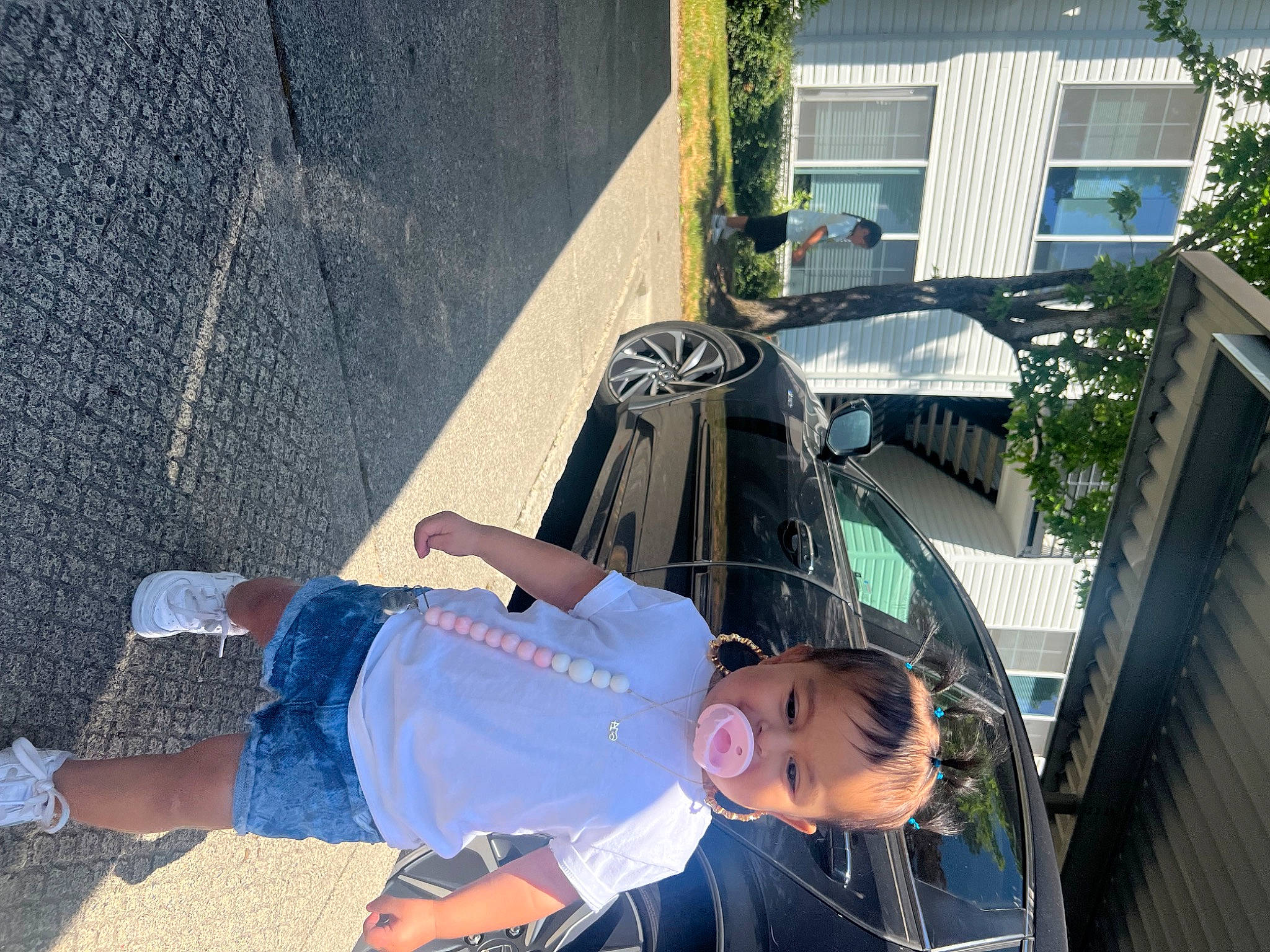 Sequoia is registered to the contest to win money with this photo: city, denim, fun, human_leg, leisure, luggage_and_bags, pedestrian, person, recreation, sandal, shoe, shorts, sidewalk, sitting, sneakers, street, t_shirt, thigh, toddler, tree