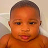 Messiah is registered to the contest to win money with this photo: baby, child, face, portrait, close_up, skin, eyes, lips, expression, head, person, cute, infant, young, indoors, human, looking, calm, smooth, curious