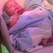 Iverson joined the competition — help win amazing prizes! baby, infant, sleeping, child, portrait, blanket, pajamas, baby_seat, chair, cozy, indoors, pink_lighting, purple_lighting, closed_eyes, hand, foot, cuddled, resting, soft_fabric, nap_time