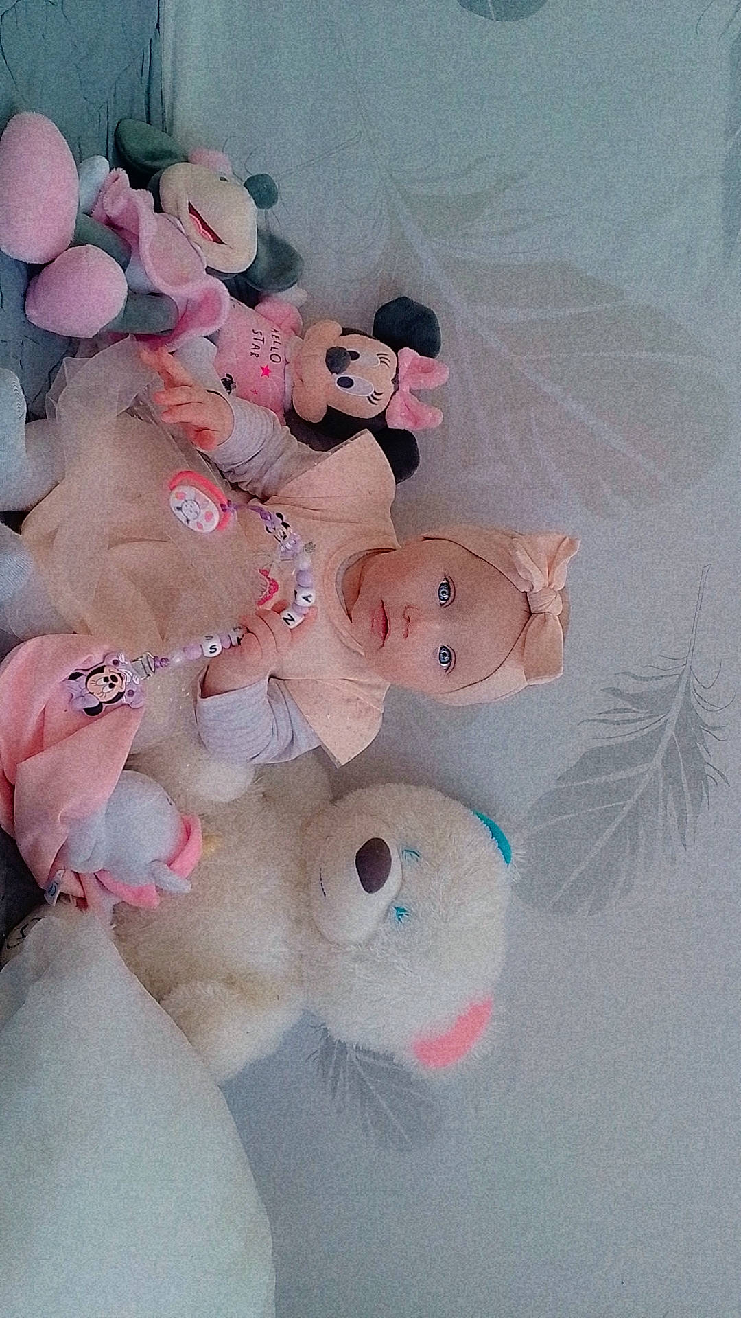 accessories, baby, bed, blanket, bonnet, clothing, couch, crib, doll, face, furniture, hat, head, homedecor, infantbed, linen, person, plush, teddybear, toy