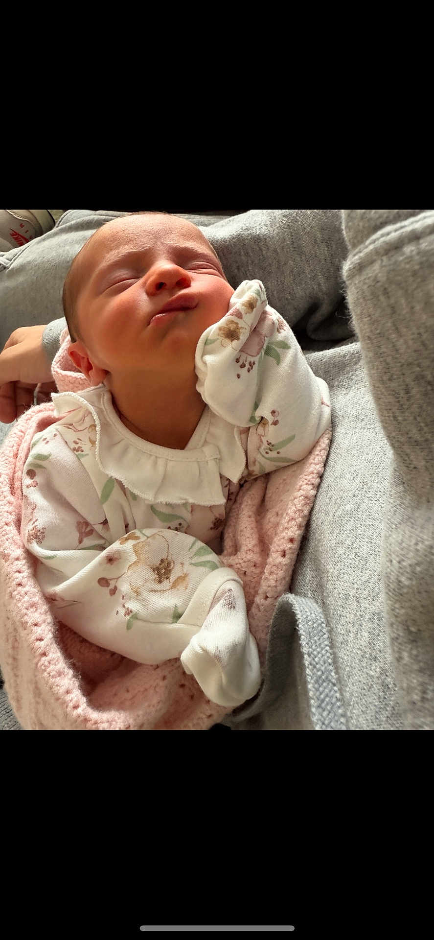 Aria is registered to the contest to win money with this photo: newborn, baby, infant, sleeping, blanket, floral_clothing, pink, white, cute, peaceful, hand, face, closeup, soft, cozy, resting, person, indoors, fabric, knitted