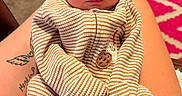 Rowan joined the competition — help win amazing prizes! newborn, baby, infant, child, portrait, face, eyes, striped_outfit, clothing, onesie, sitting, lap, adult, arms, tattoo, indoor, rug, cozy, photograph, serious_expression