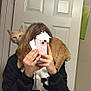 Steve joined the competition — help win amazing prizes! cat, person, mirror, selfie, phone, indoor, door, shoulder, curious, ginger_cat, hair, black_clothing, white_door, wall_art, hand, fingers, reflection, pet, animal, casual