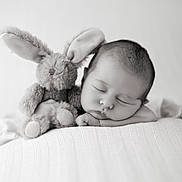 Célestin participe au concours pour gagner de l'argent avec cette photo : baby, black_and_white, blanket, bunny, calm, child, closeup, cuddly, cute, face, head, indoors, infant, peaceful, portrait, resting, sleeping, soft_texture, stuffed_animal, toy
