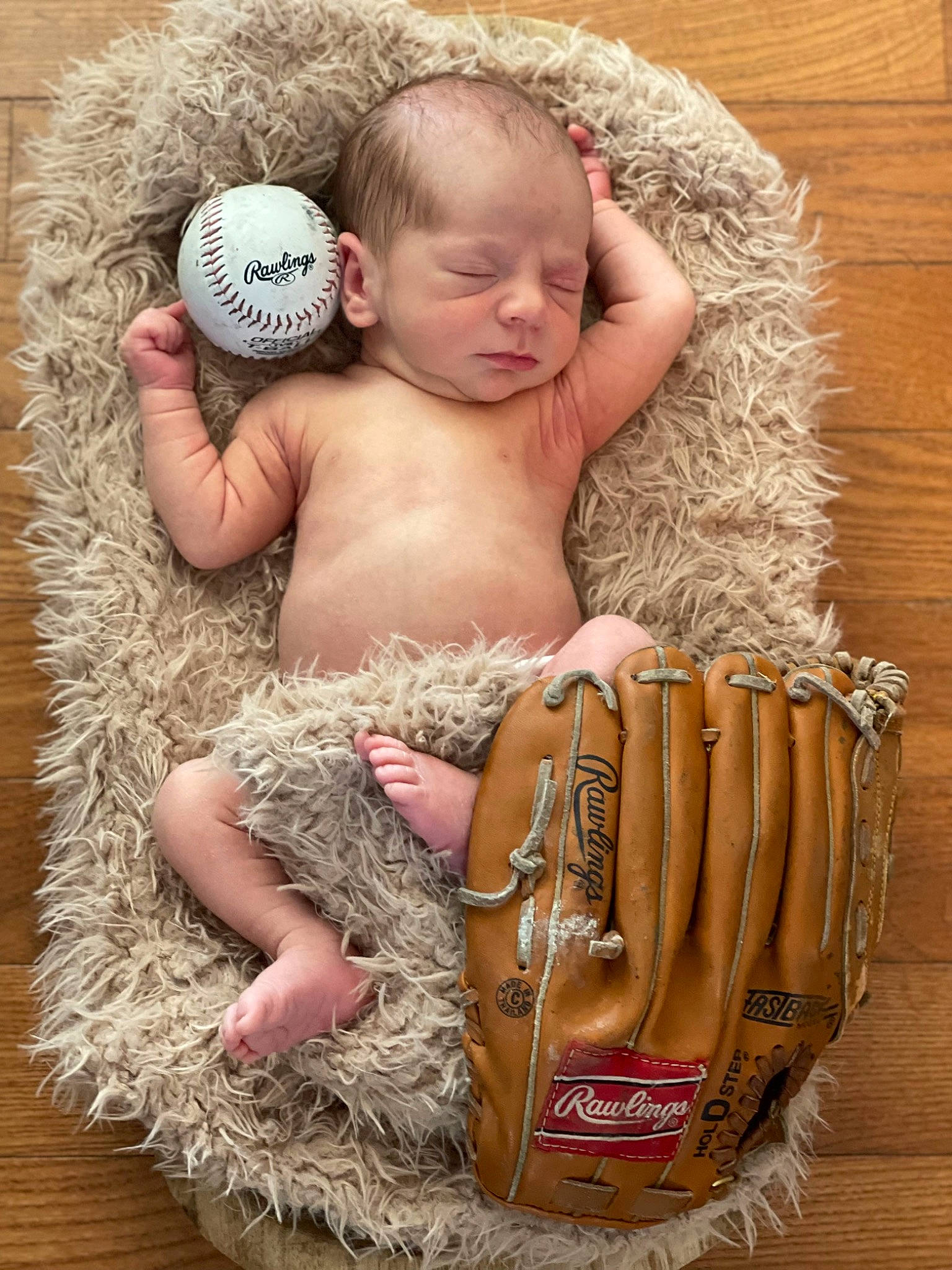 Issac is registered to the contest to win money with this photo: abdomen, baby, baby_toddler_clothing, basket, child, fashion_accessory, finger, foot, fur, grass, human_leg, jewellery, person, picnic_basket, sitting, storage_basket, toddler, toy, wicker, wood