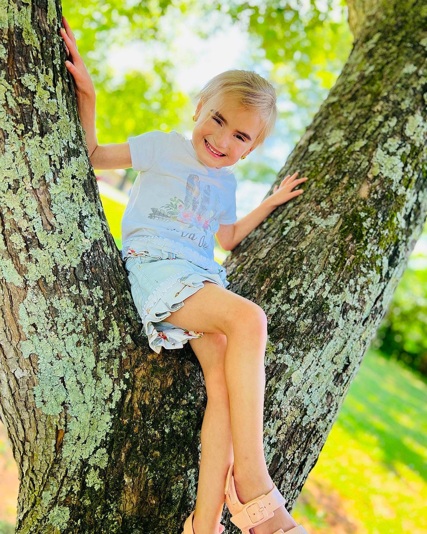 Chasity is registered to the contest to win money with this photo: botany, branch, eye, face, hair, hairstyle, happy, head, human_body, joy, leaf, leg, nature, people_in_nature, person, plant, shorts, smile, sunlight, tree