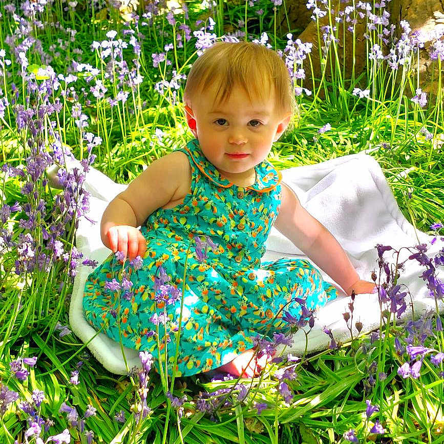 Amelia joined the competition — help win amazing prizes! clothing, dress, face, flower, garden, geranium, grass, green, head, herbal, herbs, nature, outdoors, person, petal, photography, plant, portrait, purple, vegetation