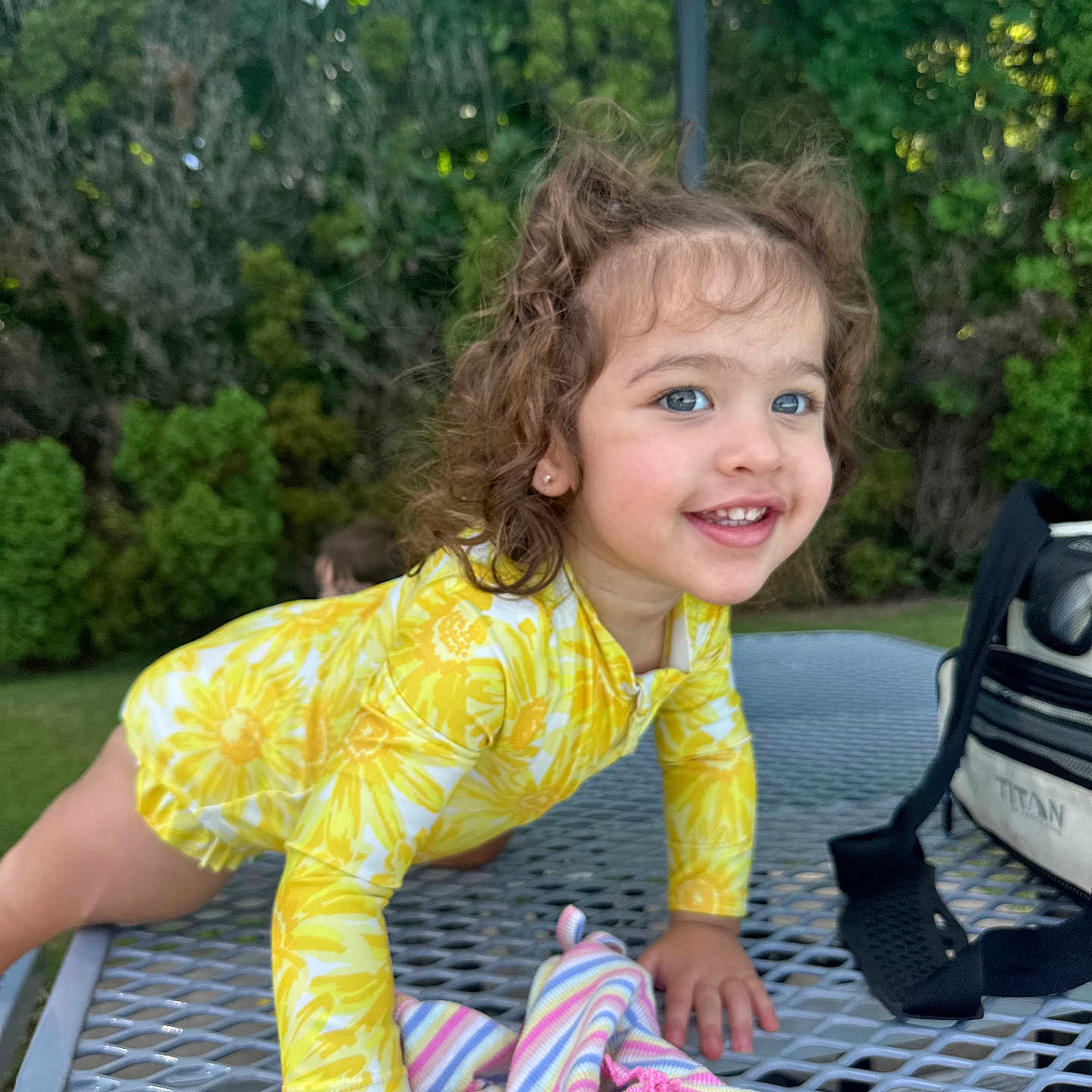 Alani is registered to the contest to win money with this photo: architecture, building, canopy, child, clothing, face, female, furniture, girl, grass, head, outdoors, person, photography, plant, portrait, shelter, shorts, sitting, summer