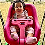 baby, bow, closeup, curly_hair, daylight, grass, happy, infant, little_tikes, outdoor, pink_clothing, pink_swing, playtime, portrait, seat, seatbelt, smiling, socks, swing, toy