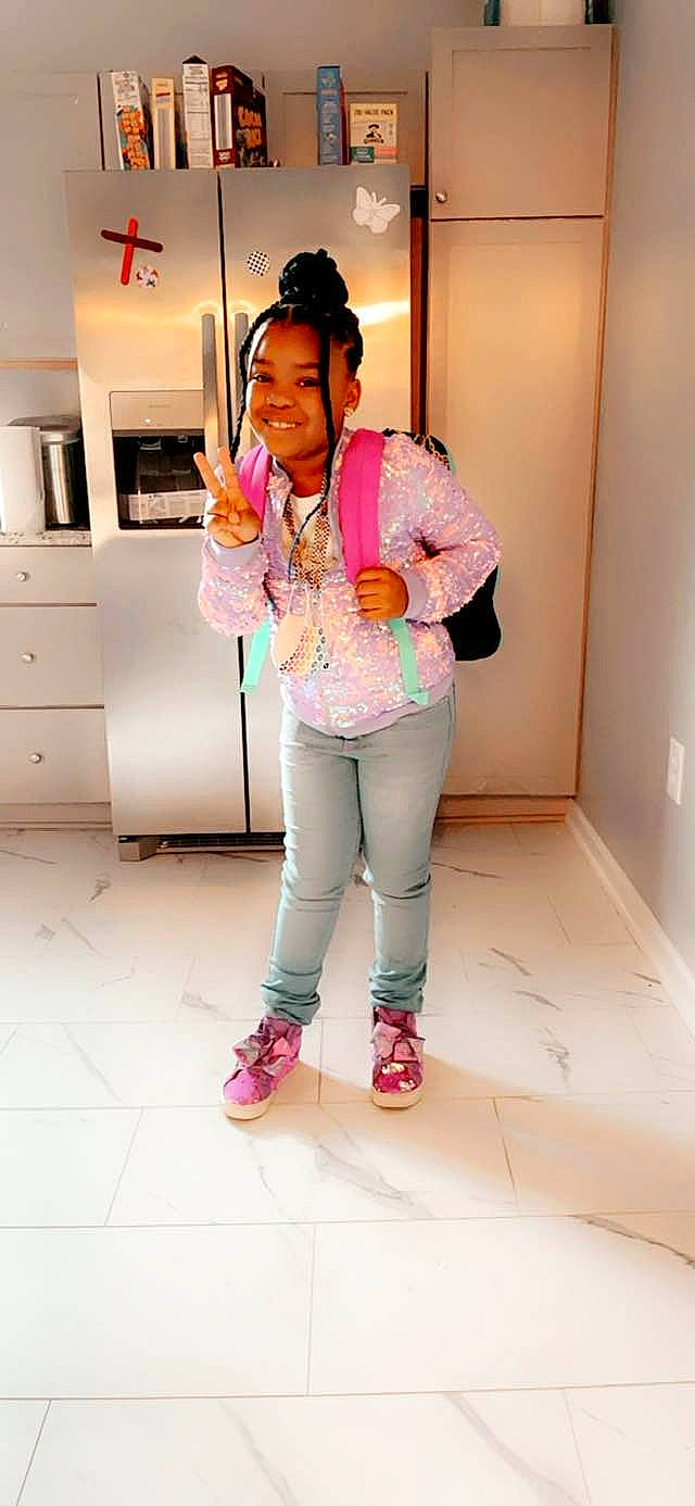 Ayanna is registered to the contest to win money with this photo: arm, bag, beauty, cabinetry, chest_of_drawers, drawer, fashion_design, human_body, human_leg, joy, knee, leg, luggage_and_bags, neck, person, pink, shoe, sleeve, smile, sneakers