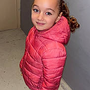 Luna participe au concours pour gagner de l'argent avec cette photo : child, girl, puffy_jacket, pink, curly_hair, smile, standing, indoors, concrete_floor, gray_wall, winter_clothing, boots, portrait, young, casual, fashion, cute, happy, person, warm_clothing