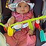 baby, infant, child, stroller, car_seat, hat, pink_dress, plush_toy, colorful_toy, outdoor, sunhat, barefoot, cute, smiling, seatbelt, soft_toy, baby_toy, child_in_stroller, person, young_child