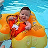 Evelyn joined the competition — help win amazing prizes! adult_hand, baby, child, face, float, happy, infant, inflatable, life_jacket, orange, outdoor, pool, portrait, recreation, safety, smiling, summer, swimming, water, wet_hair