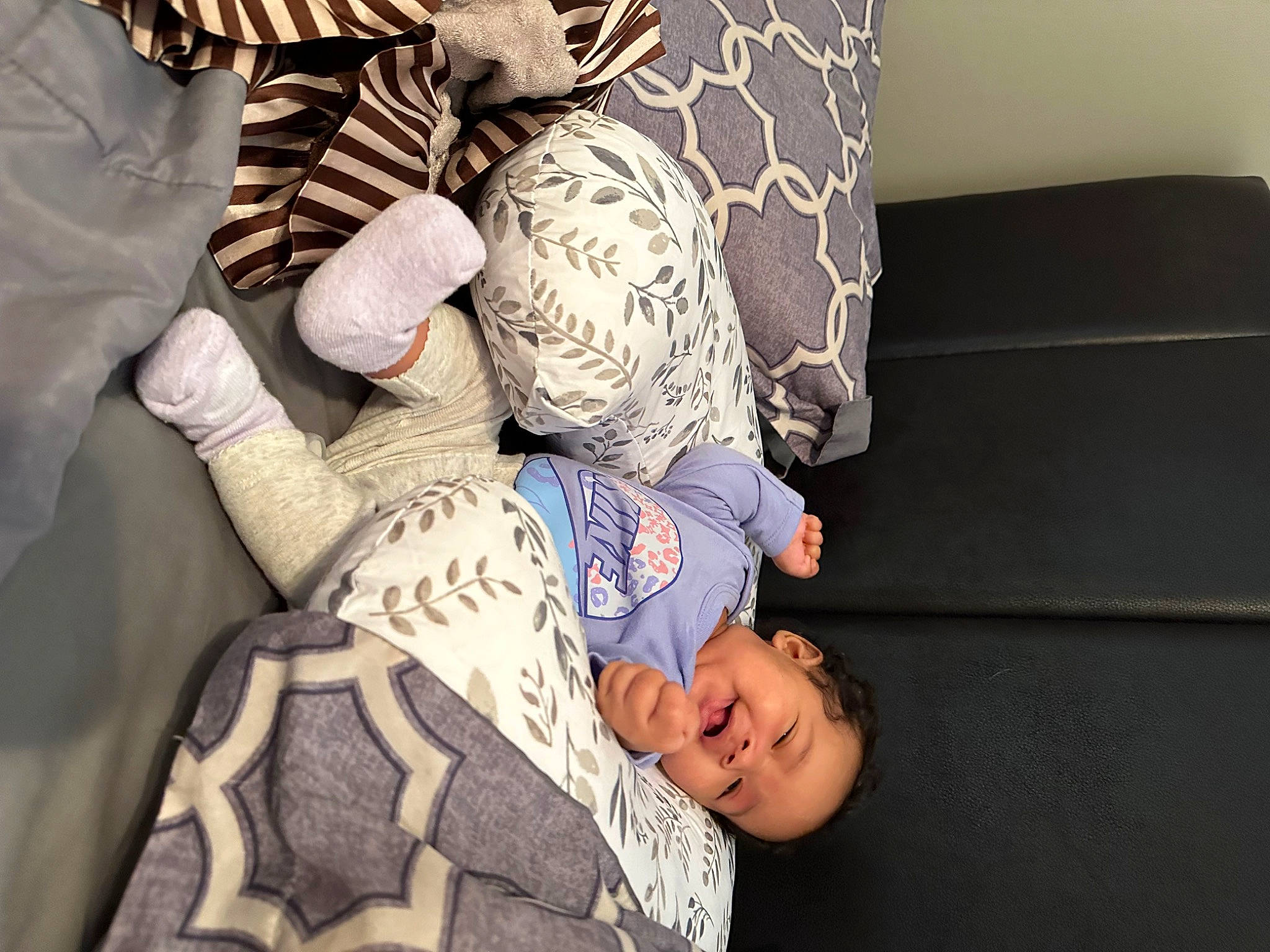 Silylah Capri is registered to the contest to win money with this photo: bedding, child, comfort, couch, elbow, flooring, gesture, hat, human_leg, lap, linens, living_room, nap, pattern, person, pillow, room, sitting, thigh, toddler