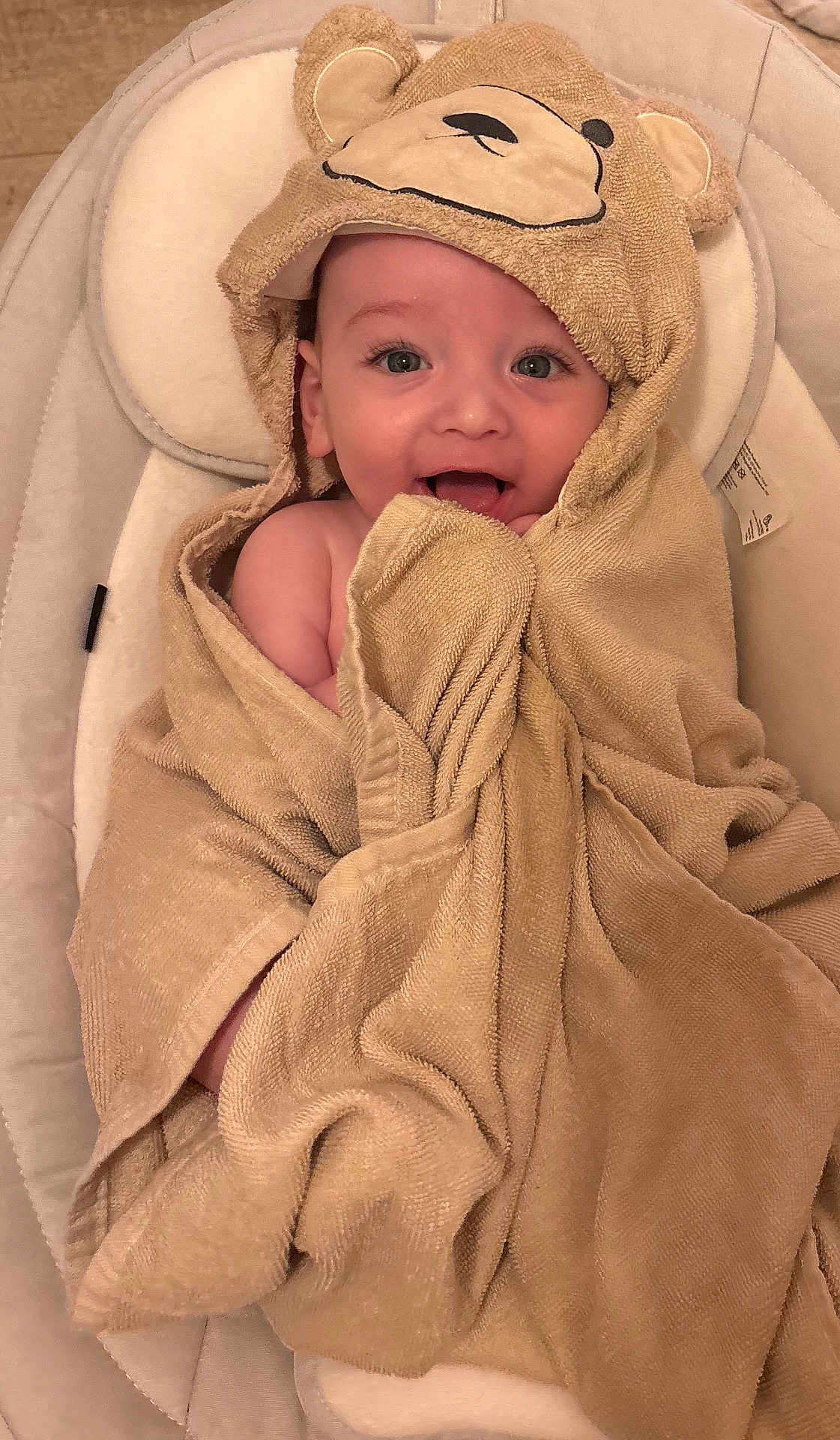 Teddy joined the competition — help win amazing prizes! baby, child, towel, bear_hood, smiling, cute, infant, wrapped, cozy, seat, cushion, happy, portrait, indoors, skin, face, head, expression, adorable, young