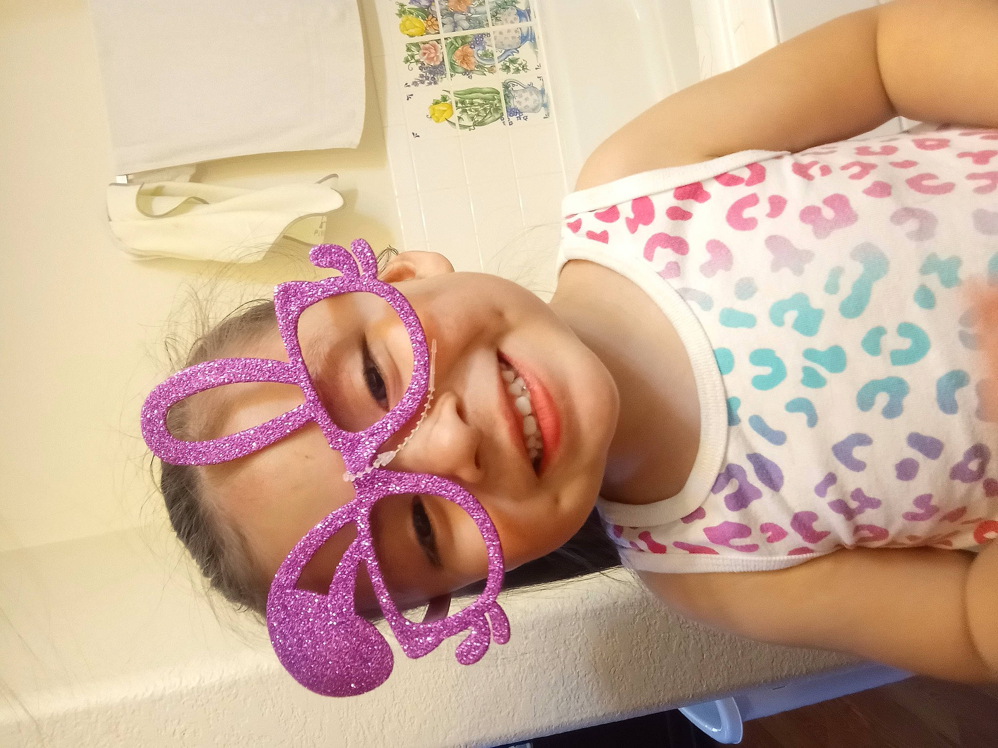 Genesis is registered to the contest to win money with this photo: chest, ear, eyebrow, eyelash, eyewear, finger, happy, headgear, human_leg, joy, lip, mouth, nail, neck, pattern, person, pink, purple, skin, smile
