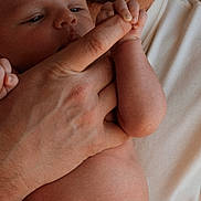Coast is registered to the contest to win money with this photo: infant, baby, newborn, diaper, hand, adult_hand, father, parent, holding, grasping, close_up, portrait, skin, fingers, beard, smile, mouth, intimacy, tenderness, home
